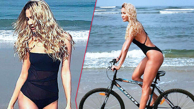 Bikini-clad Lisa Haydon strikes a pose while cycling!
