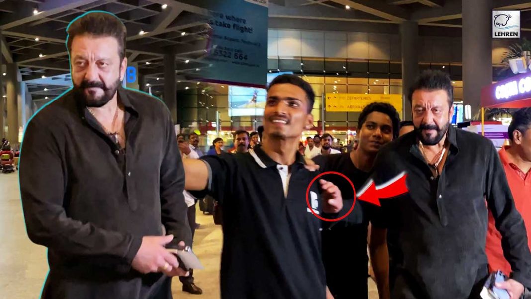 sanjay dutt pushes a fan at airport